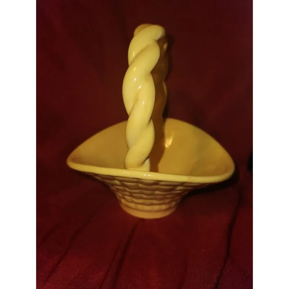 yellow ceramic basket has Leitsch on bottom